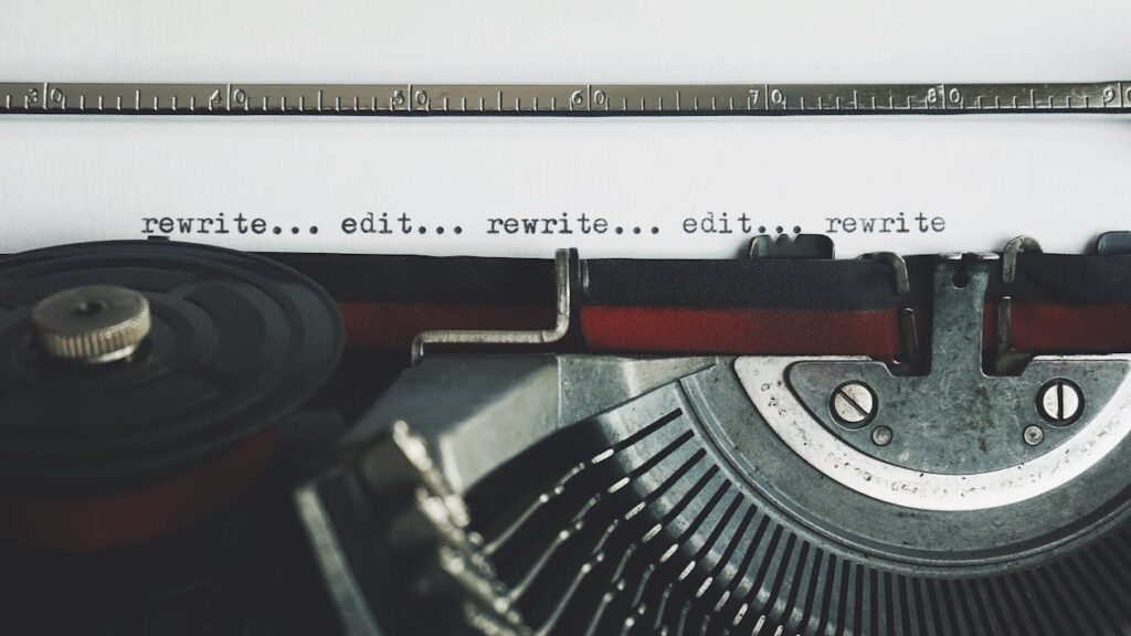 A typewriter with the tips "rewrite... edit... rewrite..." written over and over on the page.